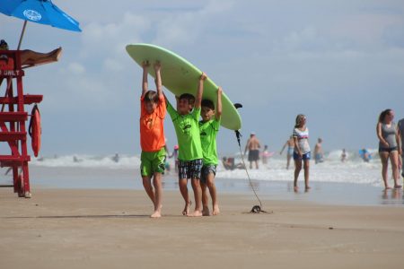Kids carrying a board together